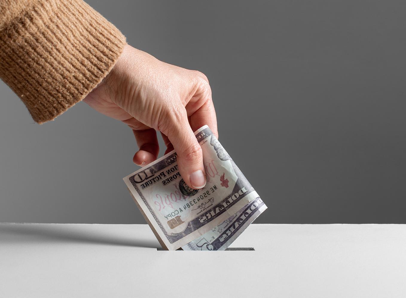 Image of someone holding cash